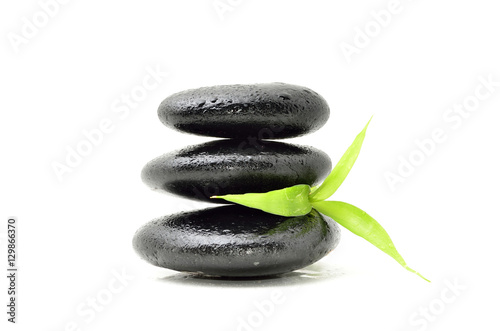 Zen stone with bamboo leaf on white background. Spa concept