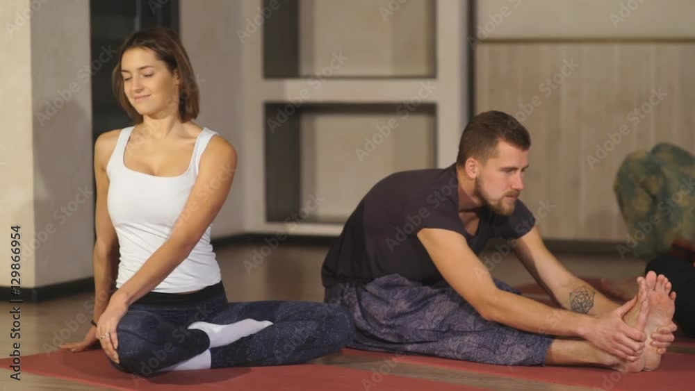 a group of people warming up before yoga