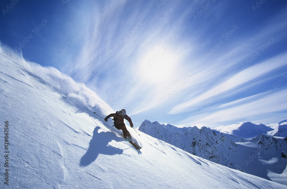 Full length of skier skiing on fresh powder snow - obrazy, fototapety, plakaty 