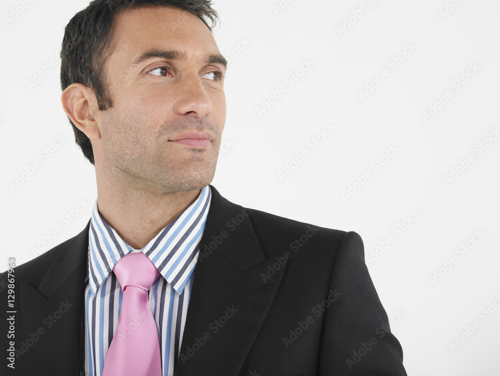 Closeup of a thoughtful businessman looking away against white background Closeup of a thoughtful businessman looking away against white background
