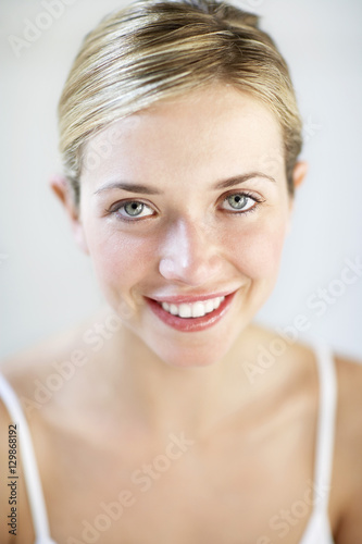 Closeup portrait of young woman smiling isolated on white background