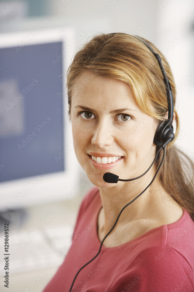 Portrait of smiling female customer service representative at desk Portrait of smiling female customer service representative at desk