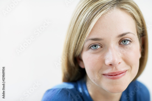 Closeup portrait of happy young woman isolated on white background