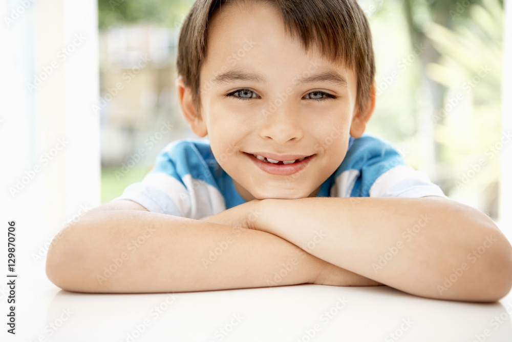 Closeup portrait of happy young boy leaning into window Closeup portrait of happy young boy leaning into window