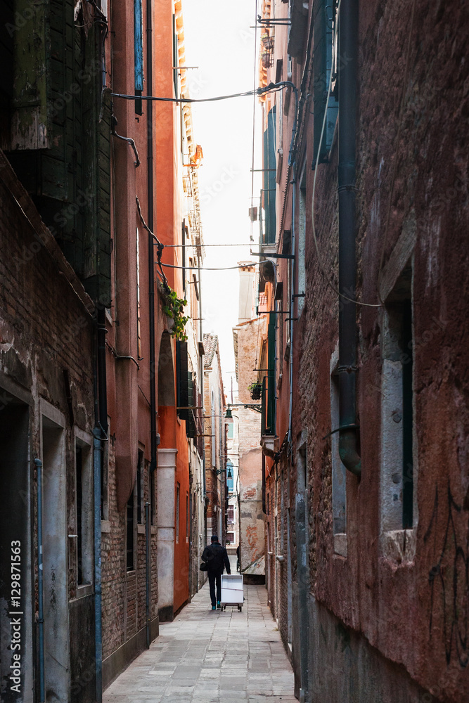 Fototapeta premium narrow street in historic area of Venice city