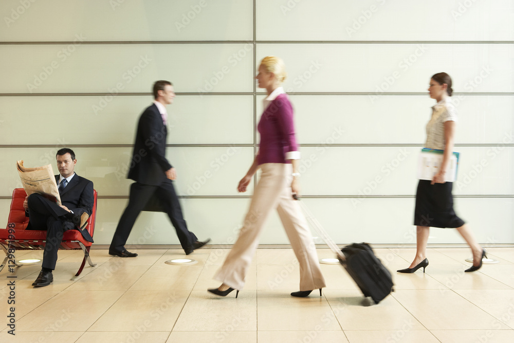 Profile shot of businesspeople walking in office corridor