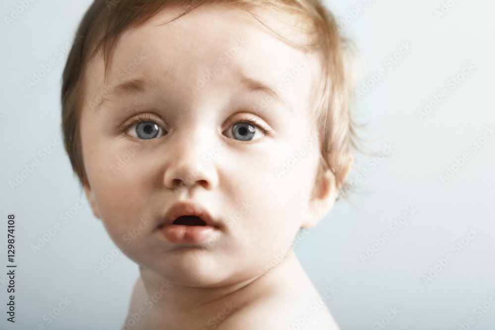 Closeup of cute baby looking at camera isolated on white background