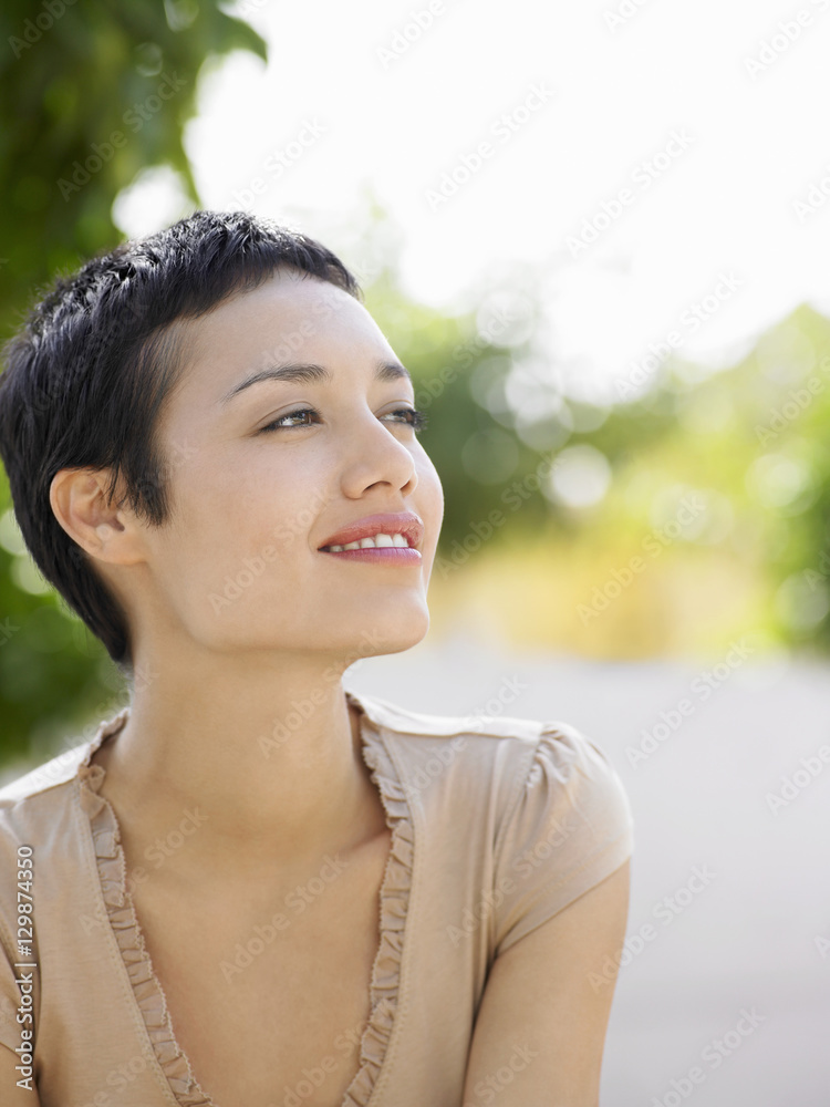 Thought young businesswoman looking away outdoors Thought young businesswoman looking away outdoors