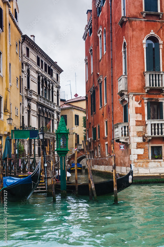mooring of gondolas near houses in Venice in rain