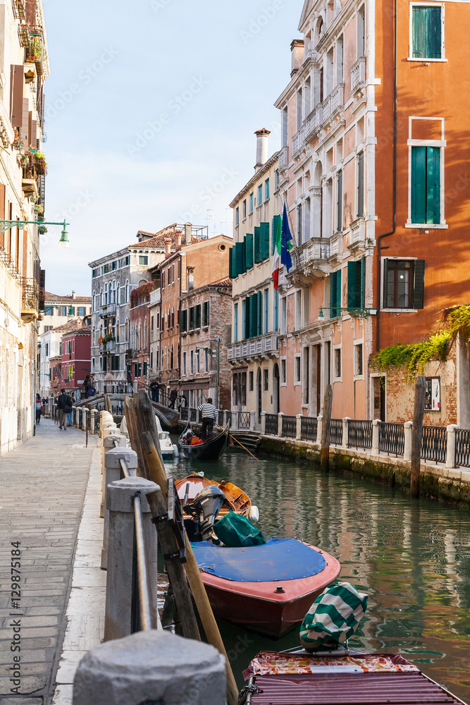 boats and gondolas in canal of Venice city