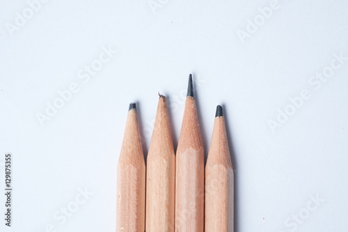 A sharpen pencil among blunt pencils on white background, present idea of smart and intelligent.