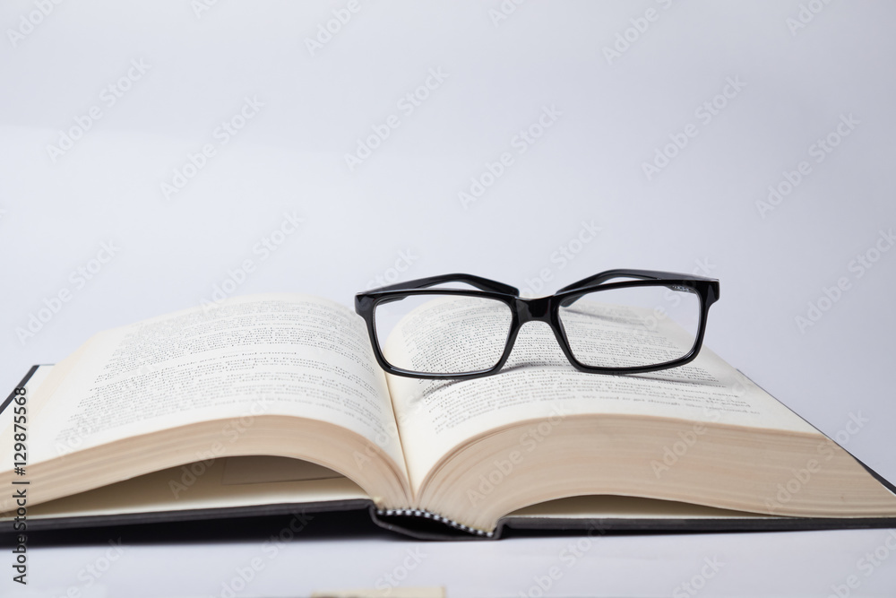 Eyeglasses on the open book. Idea of happy reading a noval and education. Eyeglasses on the open book. Idea of happy reading a noval and education.