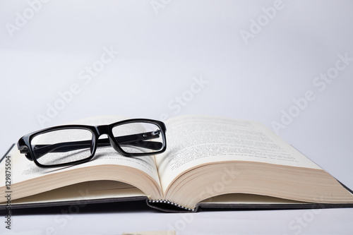 Eyeglasses on the open book. Idea of happy reading a noval and education.