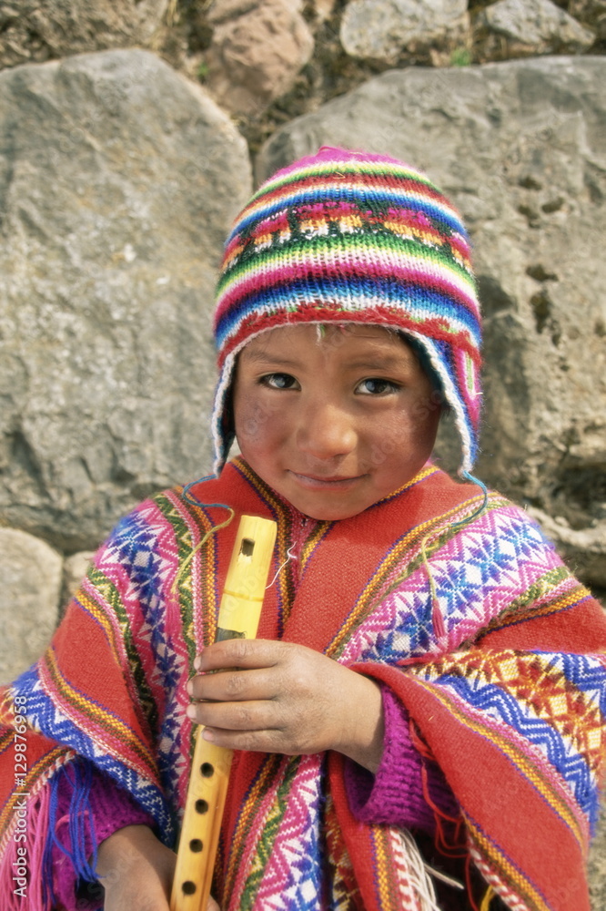 Portrait of a Peruvian boy in a knitted hat, playing the flute, near Cuzco,  Peru Stock Photo | Adobe Stock