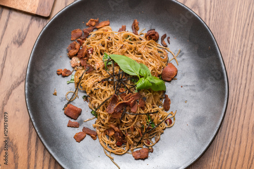 Spicy spaghetti with bacon and basil 
