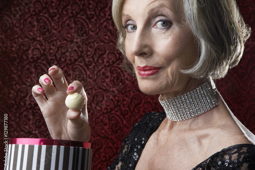 Fotografija Closeup portrait of a wealthy senior woman with box of candy