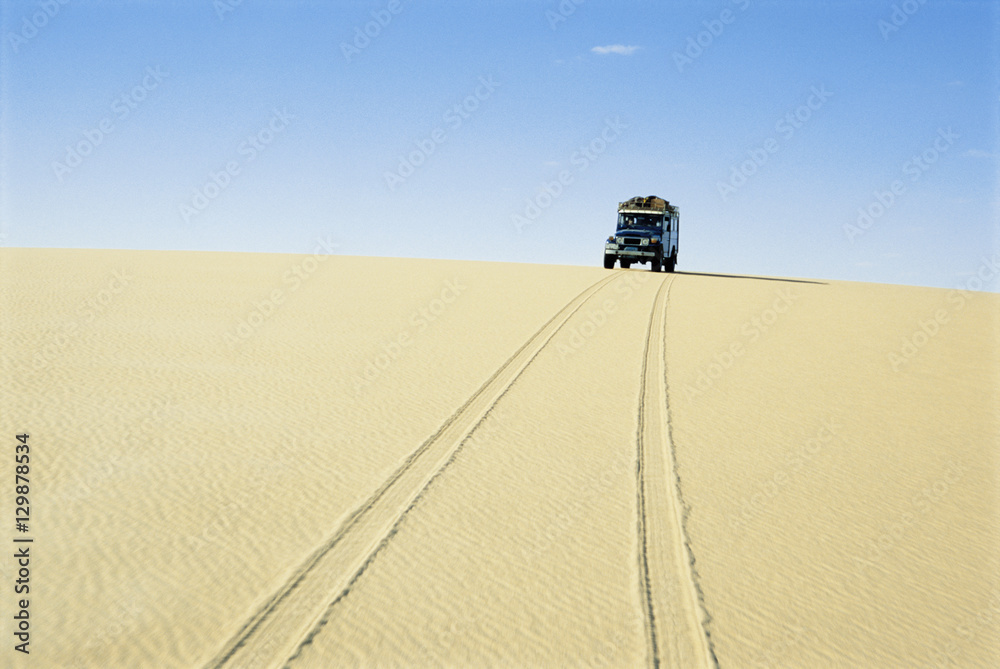 Jeep following tire track in the desert Jeep following tire track in the desert