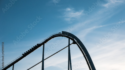 Roller coaster against blue sky