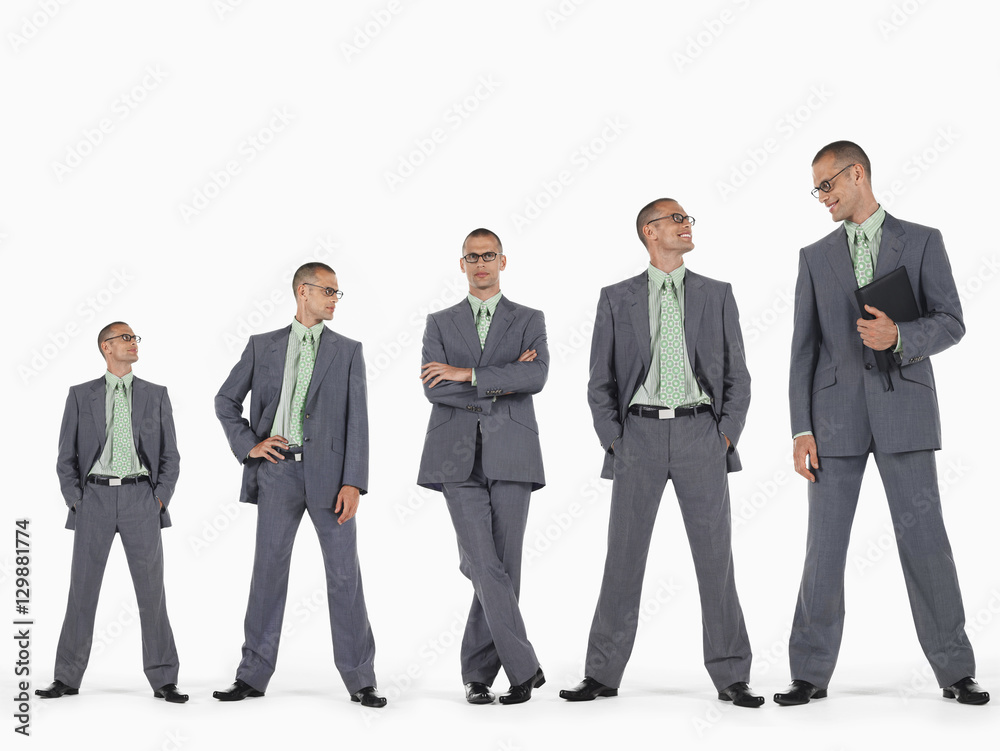 Row of businessmen in ascending order of height against white background Row of businessmen in ascending order of height against white background