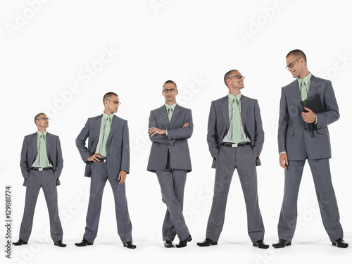 Obraz na płótnie Row of businessmen in ascending order of height against white background