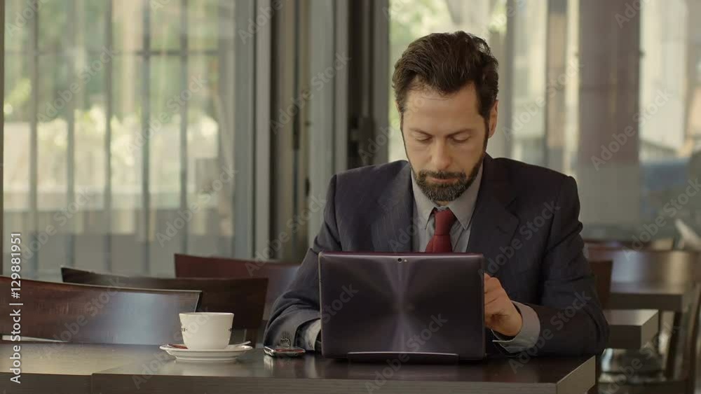 angry businessman with problems at work answers at the mobile phone angry businessman with problems at work answers at the mobile phone