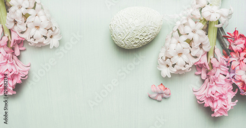 Easter banner with hyacinths and decor egg on light pastel wooden background, top view, place for text