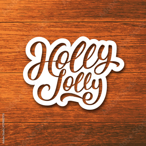 Holly Jolly text on paper label with hand lettering over wooden background. Sticker or greeting card vector design template for Christmas.