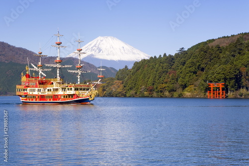 Tourist pleasure boat on lake Ashino-ko with the red torii gates of Hakone-jinja rising from the lake and snow capped Mount Fuji beyond, Fuji-Hakone-Izu National Park, Hakone, Central Honshu (Chubu), Japan photo
