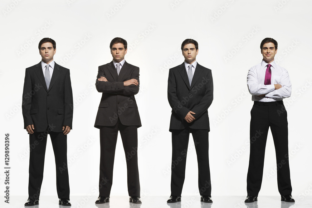 Full length portrait of businessmen standing side by side against white background
