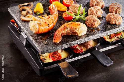 Photography Prawn tails and meatballs cooking with raclette