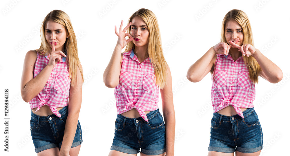 Fototapeta premium Blonde girl making silence gesture