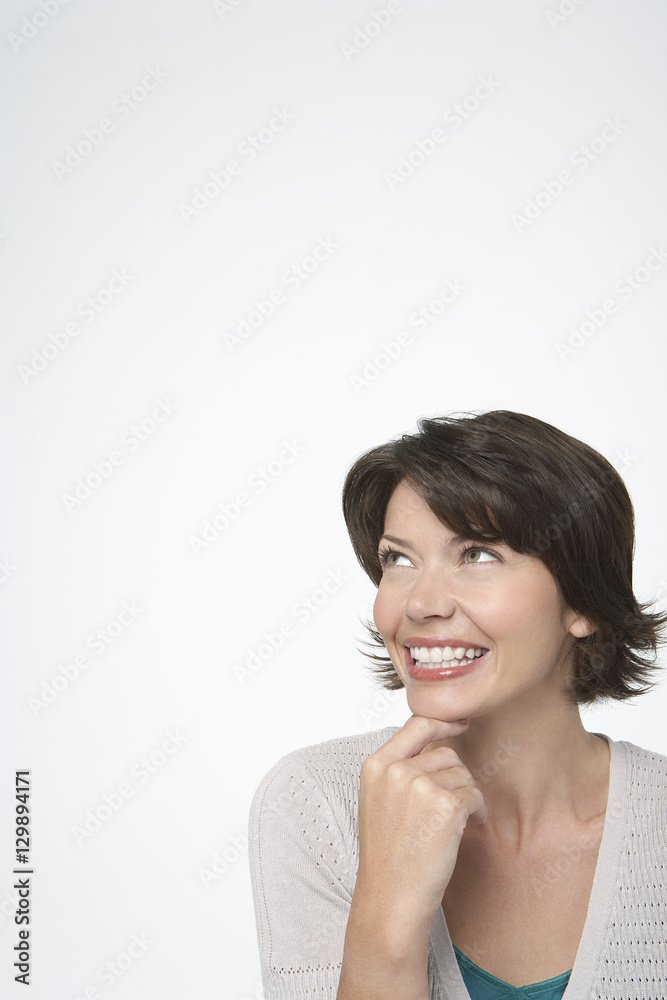 Cheerful woman looking at copyspace isolated over white background Cheerful woman looking at copyspace isolated over white background