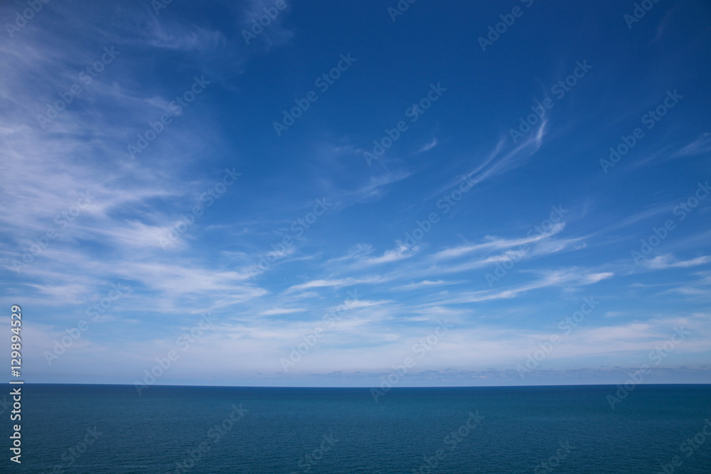 Clouds, blue sky, calm sea. And skyline