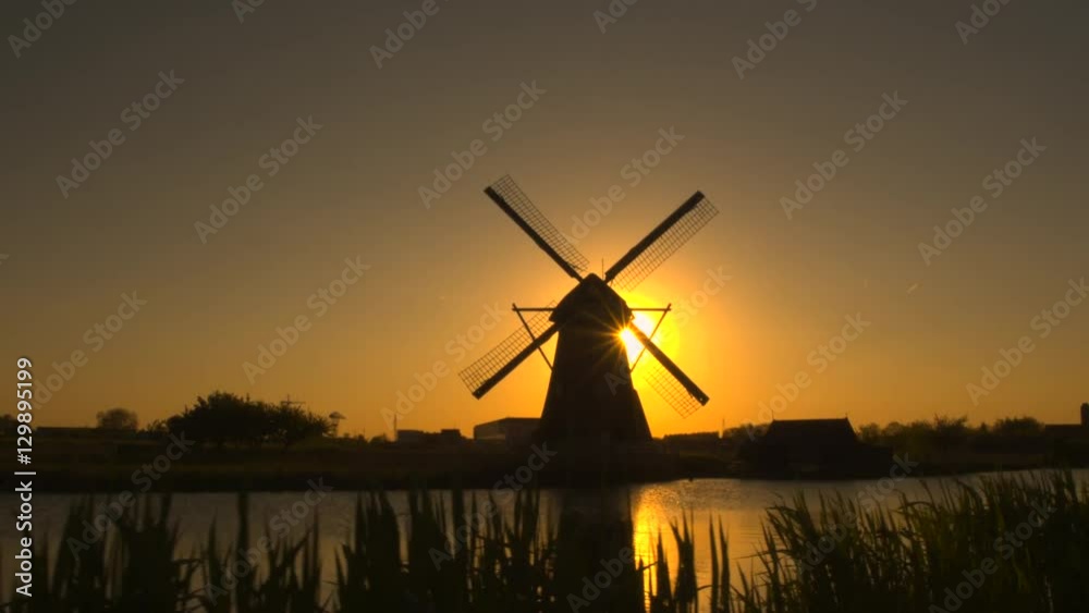 Aerial amazing old traditional Dutch windmill at beautiful golden sunset 