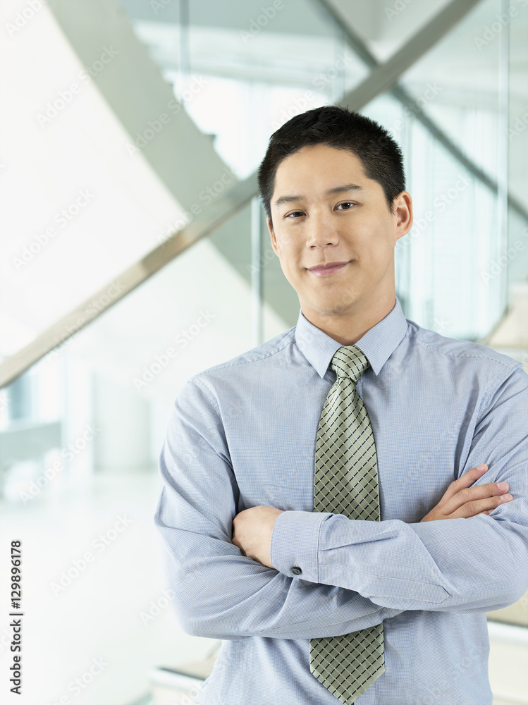 Portrait of a confident smiling businessman standing with arms crossed Portrait of a confident smiling businessman standing with arms crossed