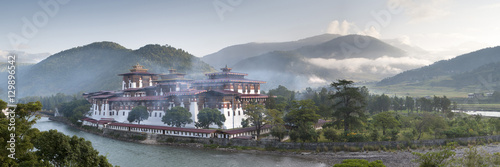 Misty dawn view of the Punakha Dzong located at the junction of the Mo Chhu (Mother River) and Pho Chhu (Father River) in the Punakha Valley, Bhutan, Himalayas