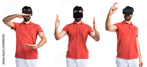 Handsome man using VR glassesa and holding something