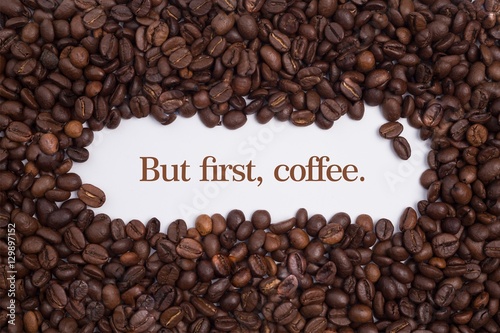 Background made of coffee beans with message  But first  coffee. 