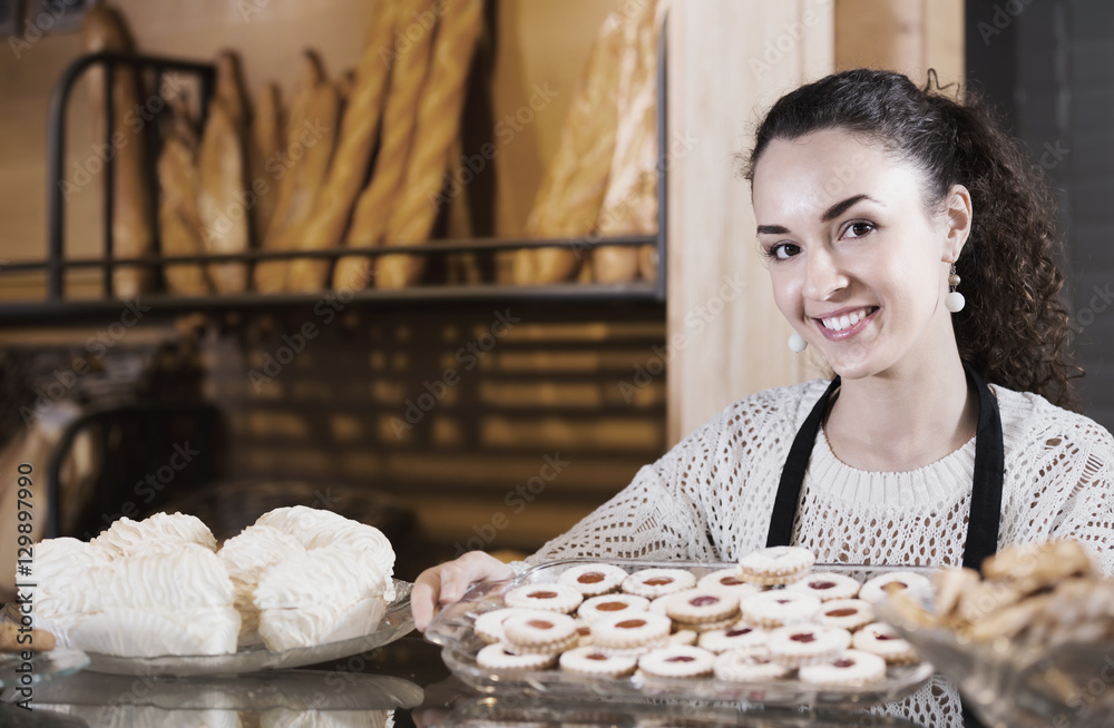 Woman selling pastry in bakery StockFoto Adobe Stock