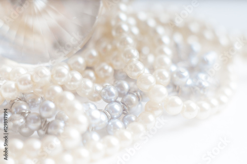 Abstract blurred background, pearl necklace on white. Macro shot, Shallow depth of field, defocused © angelus_liam