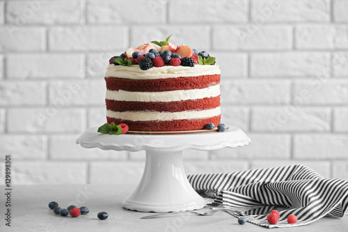 Bild auf Leinwand Delicious cake with fruit and berries decoration on gray table