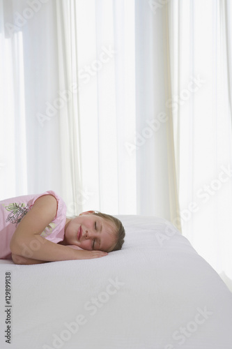 Young girl sleeping in bed