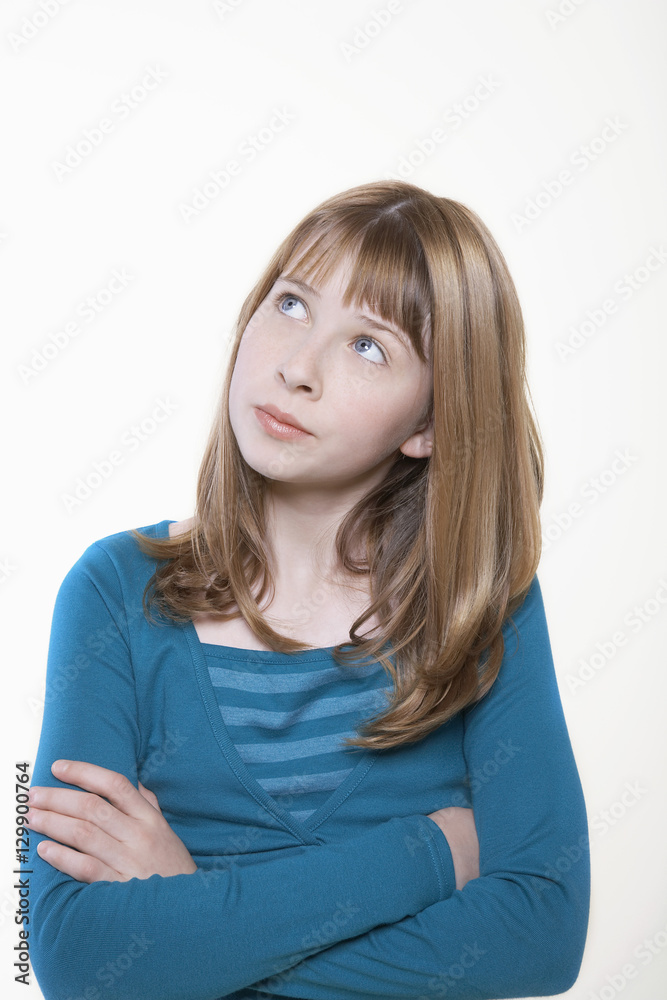 Teenage girl with hands folded looking away isolated on white background Teenage girl with hands folded looking away isolated on white background