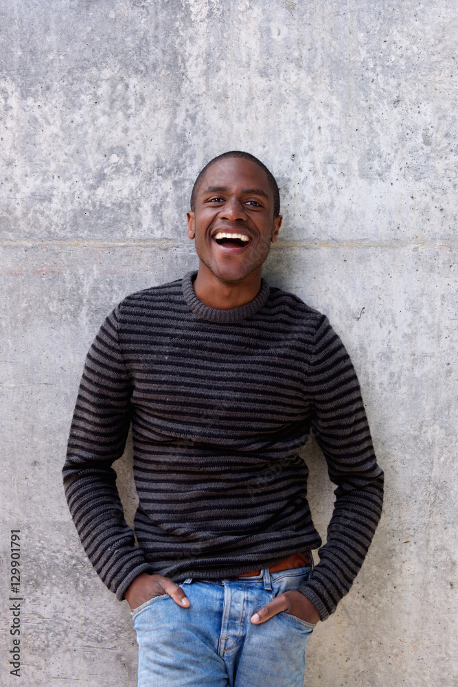 cheerful african american man in sweater with hands in pockets cheerful african american man in sweater with hands in pockets