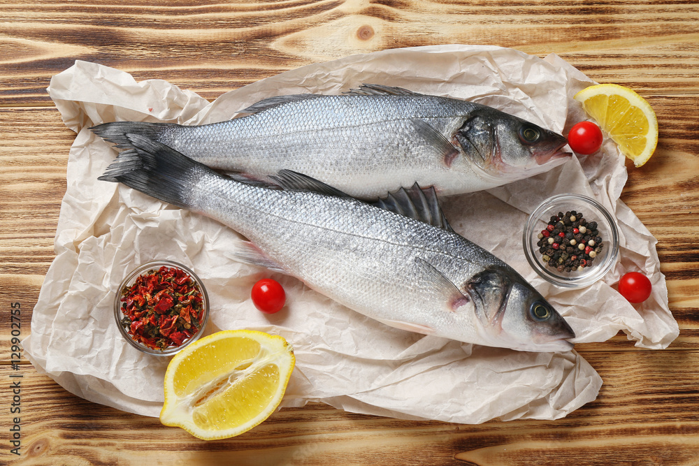 Raw fish with spices on wooden table Raw fish with spices on wooden table