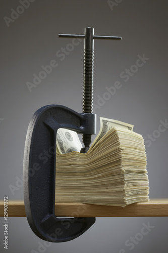 Vise gripping stack of banknotes