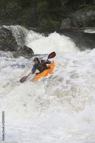 View of a man kayaking in rough river