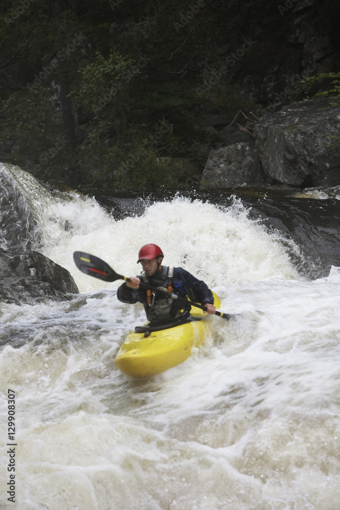 View of a man kayaking in rough river