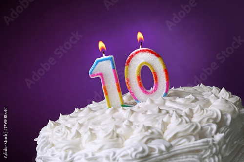 Birthday cake with candles on color background