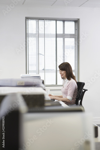 Young businesswoman working on desktop pc in office © moodboard